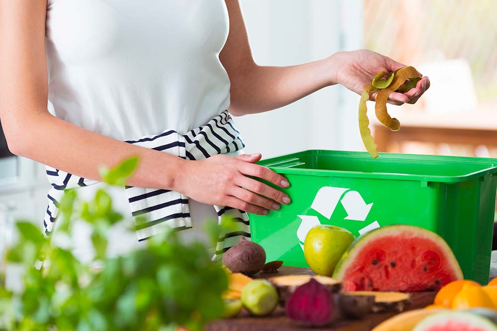 woman composting organic kitchen waste 2021 08 26 15 43 10 utc